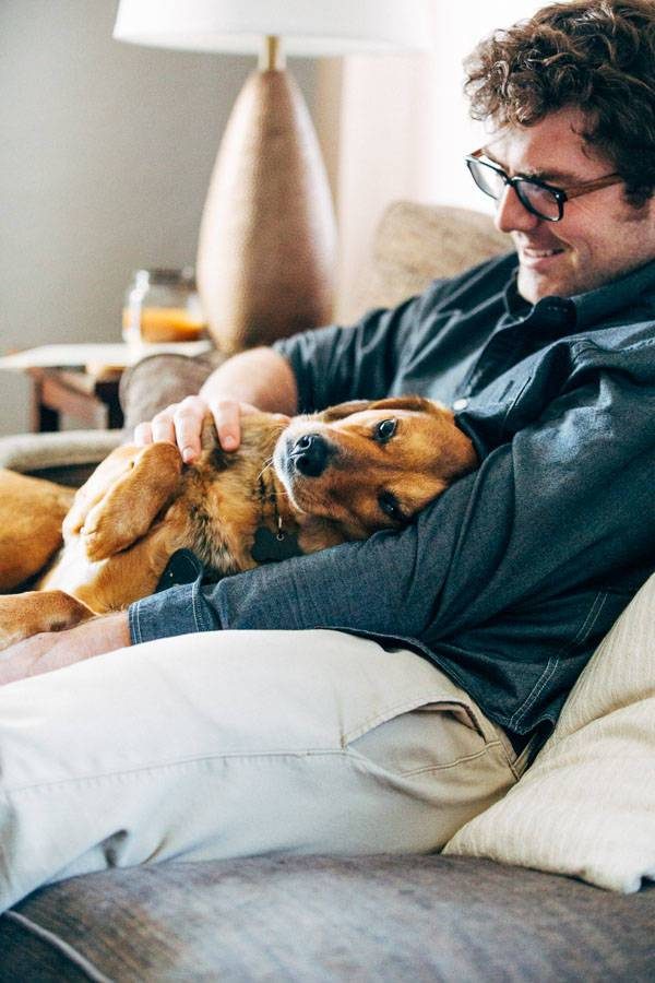 Man kissing a dog.