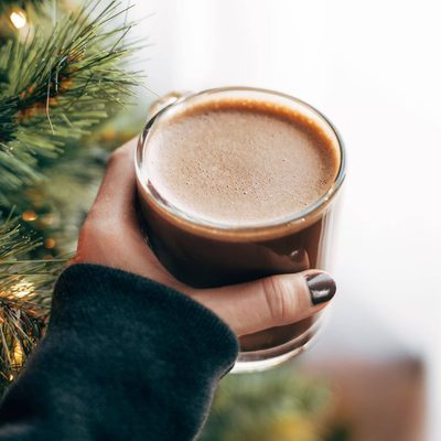 Bulletproof Peppermint Mocha in hand by tree.