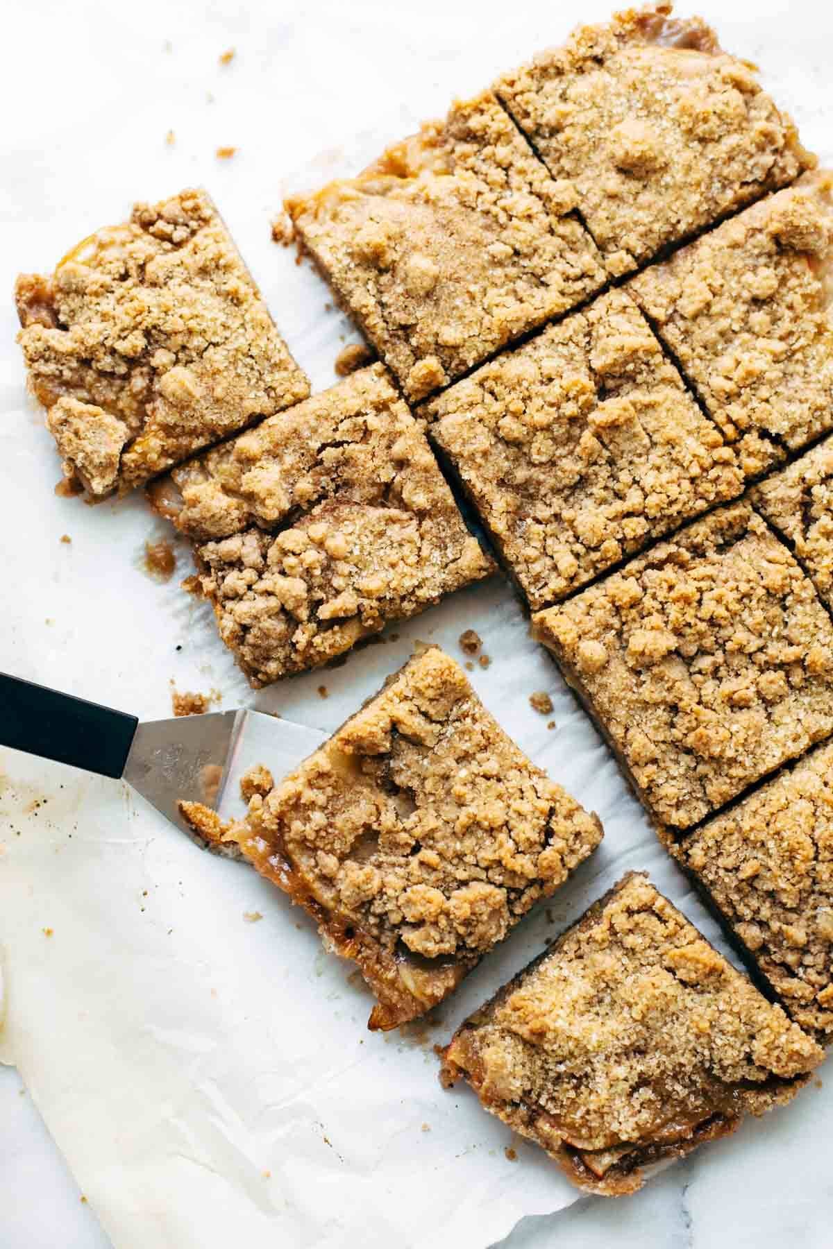 These layered bars are so simple! Loaded with homemade caramel and apples. Caramely apple layer tucked in by a brown sugar-y crust on both sides. | pinchofyum.com These layered bars are so simple! Loaded with homemade caramel and apples. Caramely apple layer tucked in by a brown sugar-y crust on both sides. | pinchofyum.com