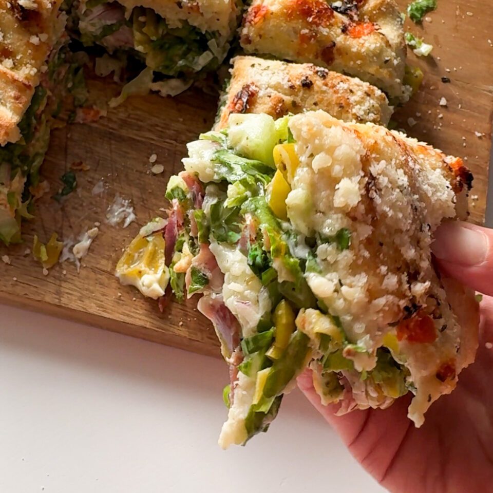 Slice of focaccia grinder sandwich.