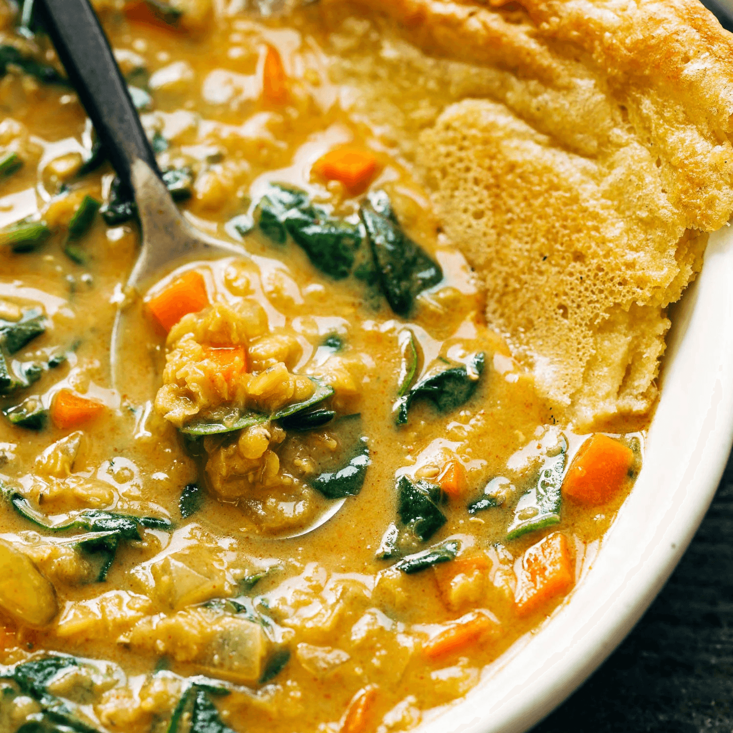Lentil soup in a bowl with socca.
